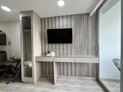 a living room with a television on a wall at Suite con balcón cerca al centro Cartagena in Cartagena de Indias
