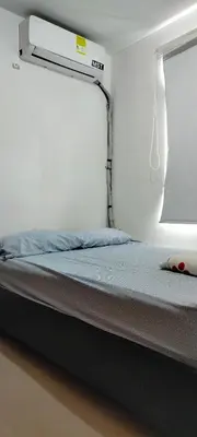 a bed in a room next to a window at Apto cómodo, confortable para descansar y Disfrutar in Cartagena de Indias