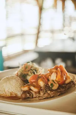 a plate of food with shrimp and rice on a table at El Embrujo Tintipan in Tintipan Island