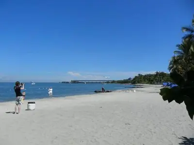 a person taking a picture of the beach at Costazul Suites 705 in Santa Marta