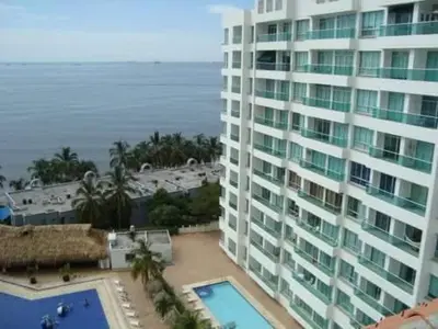 a view of a large building and the ocean at Costazul Suites 705 in Santa Marta