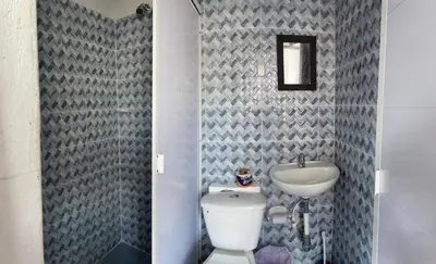 a bathroom with a white toilet and a sink at sophia house in Cartagena de Indias
