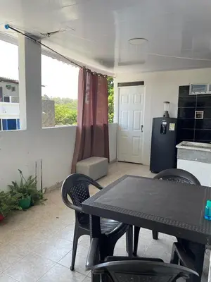 a table and chairs in a room with a kitchen at sophia house in Cartagena de Indias