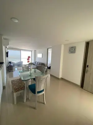 a living room with a glass table and chairs at Vista mar!! in Cartagena de Indias