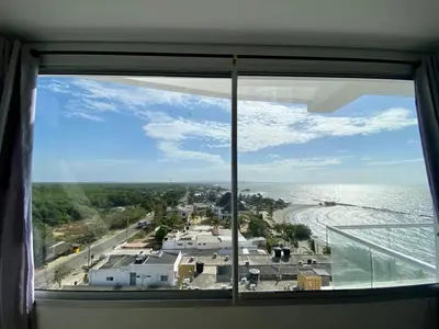 a window with a view of a beach and the ocean at Magico Apartamento Frente al Mar 3 Habitaciones FB73 in Coveñas