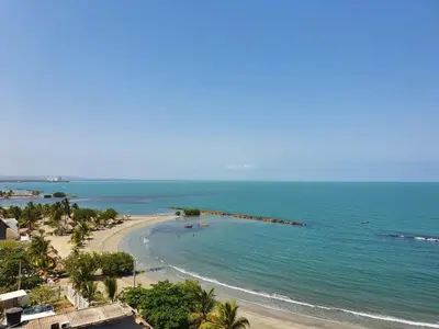 a view of a beach with people in the water at Magico Apartamento Frente al Mar 3 Habitaciones FB73 in Coveñas