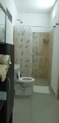 a bathroom with a shower and a toilet and a sink at Cabañas La Cuchita RNT 61621 in Coveñas