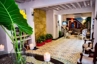 a living room with a table and a lobby at Hotel Boutique Callecitas de San Diego in Cartagena de Indias