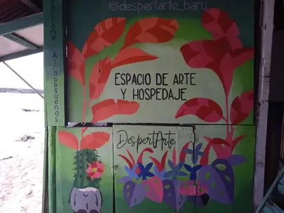 a sign on a door with a painting on it at DespertArte espacio de Arte y Hospedaje in Playa Blanca