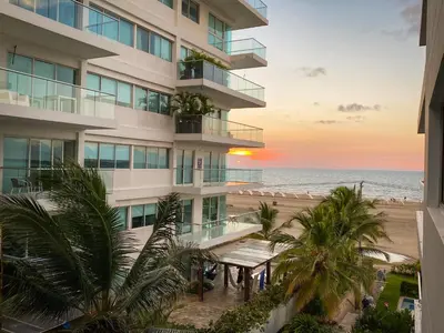 an apartment building overlooking the beach at sunset at Vista al mar en Cartagena , Apartamento en Morros in Cartagena de Indias