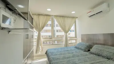 a bedroom with a bed and a large window at APARTAMENTO MARINARE DE 2 HABITACIONES CON SALIDA DIRECTA A LA PLAYA in Cartagena de Indias