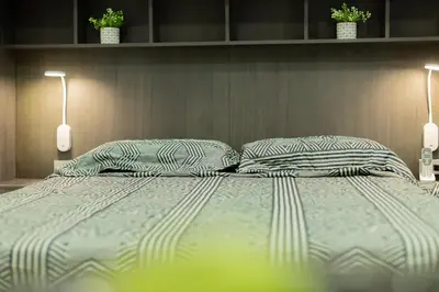 a bedroom with a large bed with two pillows at APARTESTUDIO MARINARE DE 1 HABITACION CON SALIDA DIRECTA A LA PLAYA m in Cartagena de Indias