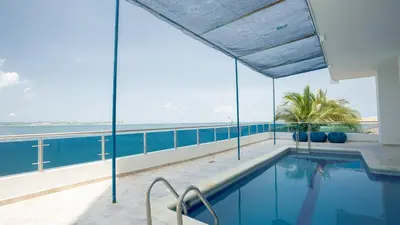 a swimming pool with a view of the ocean at APARTESTUDIO MARINARE DE 1 HABITACION CON SALIDA DIRECTA A LA PLAYA m in Cartagena de Indias