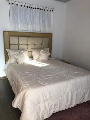 a large white bed with white sheets and pillows at Casa Hotel Alborada in San Antero