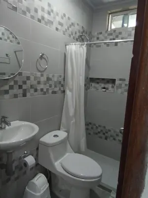 a bathroom with a toilet and a sink and a shower at Casa Hotel Alborada in San Antero