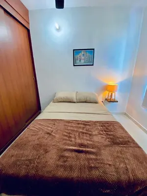 a bedroom with a large bed with a brown rug on it at La palma- casa amoblada Palma Mayorca in Sincelejo
