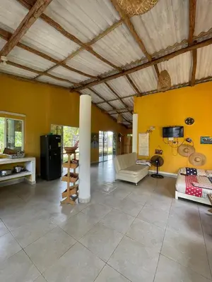 a large living room with a couch and a tv at Cabaña cerca al mar - A 200 mts in Coveñas
