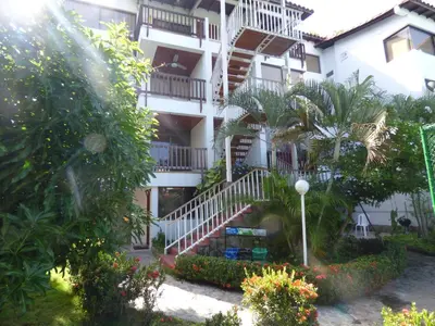 a white building with stairs and trees and plants at Puesta del sol in Santa Marta