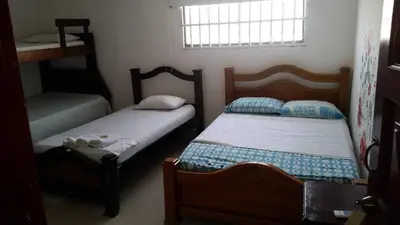 a bedroom with two beds and a window at hotel interamericano in Barranquilla