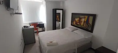 a bedroom with a bed and a painting on the wall at hotel interamericano in Barranquilla