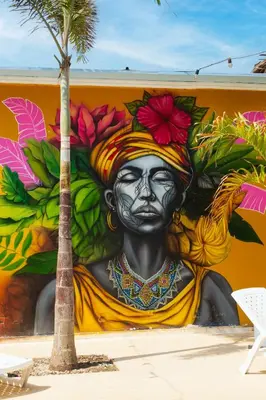 a mural of a woman painted on a wall at Hotel Coco Beach by Croma in Cartagena de Indias