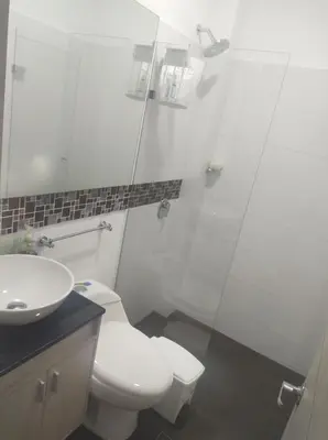 a bathroom with a white toilet and a sink at Loft 39 Casa de playa in Coveñas
