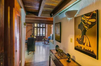 a living room with a painting of a woman on the wall at Casa Cordoba Román in Cartagena de Indias