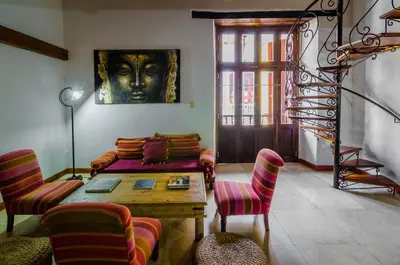 a living room with a couch and a head on the wall at Casa Cordoba Román in Cartagena de Indias