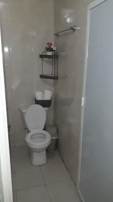 a white bathroom with a toilet and a shower at La casita de max y tim apt 202 in Cartagena de Indias