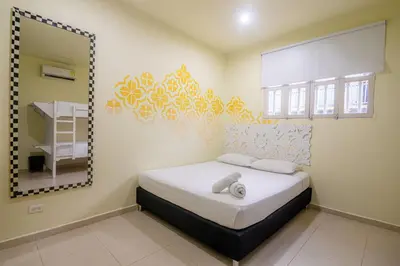 a bedroom with a bed and a large mirror at San Felicin Hostel in Cartagena de Indias