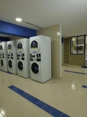 a row of washers and dryers in a building at LivinnX Barranquilla in Barranquilla