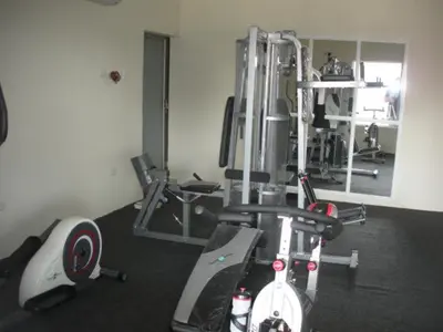 a room with a gym with a bike and weights at Hotel Rivera Del Mar in Barranquilla