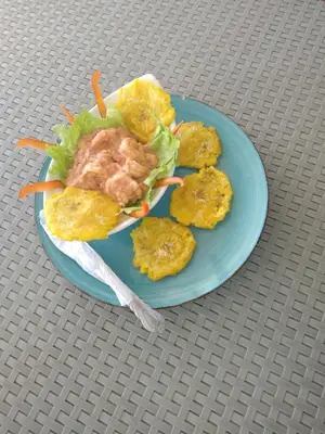 a blue plate of food on a table at posada donde Uriel Playa tranquila in Baru