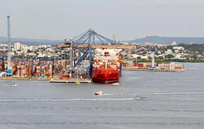 a large ship in the water next to a city at Apartamento Edificio Portofino 701 in Cartagena de Indias