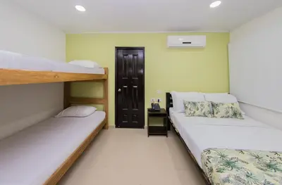 a bedroom with two bunk beds and a door at Hotel Marina Suites By GEH Suites in Cartagena de Indias