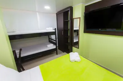 a room with bunk beds and a flat screen tv at Hotel Marina Suites By GEH Suites in Cartagena de Indias