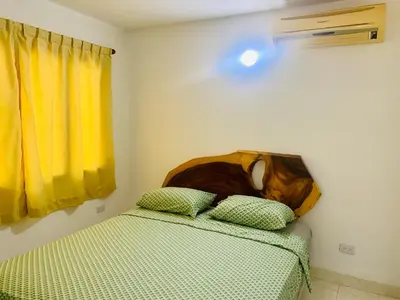 a dog laying on top of two beds in a room at Santa Marta Bello Horizonte - Cabañas Don Rafa in Santa Marta