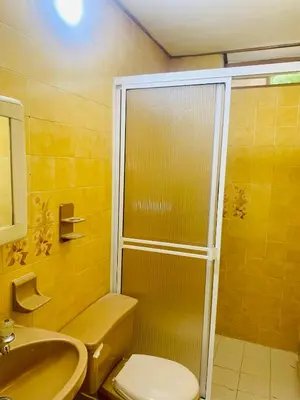 a bathroom with a shower and a toilet and a sink at Santa Marta Bello Horizonte - Cabañas Don Rafa in Santa Marta