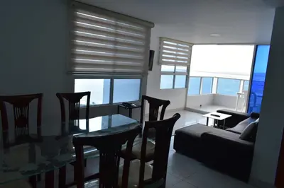 a living room with a glass table and chairs at Apartamento en Cartagena Edificio El conquistador Sector el Laguito - By Corfeinco in Cartagena de Indias