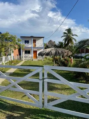 a white fence in front of a house at Cabaña La Blanquita in San Bernardo del Viento