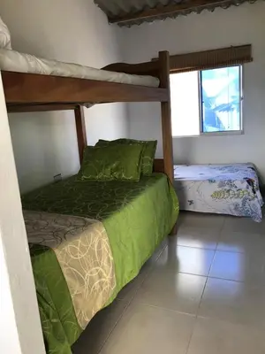 a bedroom with two bunk beds in a room at Cabaña La Blanquita in San Bernardo del Viento