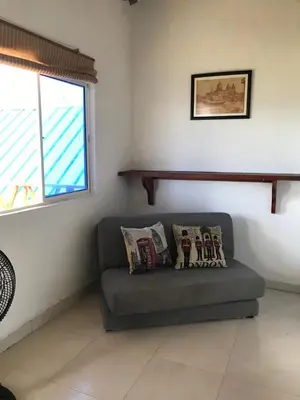 a living room with a couch and a window at Cabaña La Blanquita in San Bernardo del Viento