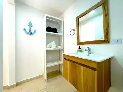 a bathroom with a sink and a mirror at Hotel Carey Beach Baru in Baru