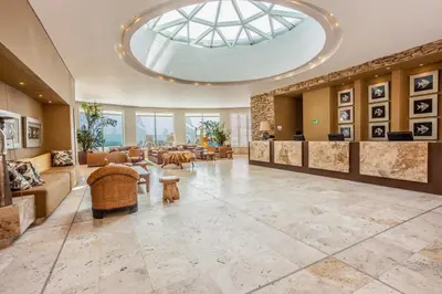 a large lobby with a large skylight at GHL Corales de Indias in Cartagena de Indias