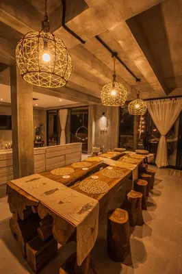 a large dining room with wooden tables and chandeliers at Sea La Vie in San Bernardo del Viento