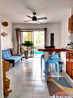 a kitchen and living room with a table and chairs at Amplio dúplex con playa y mall a una cuadra in Santa Marta
