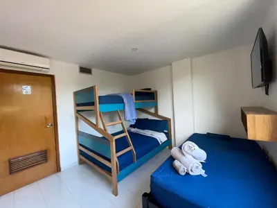 a bedroom with two bunk beds and a ladder at A metros de las playas de Bello Horizonte y de Centro Comercial Zazue in Santa Marta