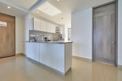 a kitchen with white cabinets and a counter top at Beachfront Paradise with Outstanding Sunset Views in Cartagena de Indias