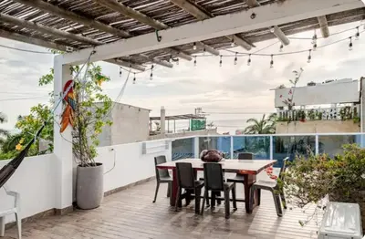 a dining room with a table and chairs on a patio at Casa con Piscina Privada Playas del Mar in Cartagena de Indias