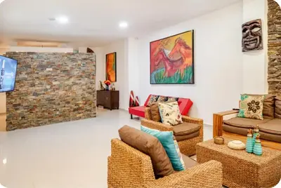 a living room with couches and a brick wall at Casa con Piscina Privada Playas del Mar in Cartagena de Indias